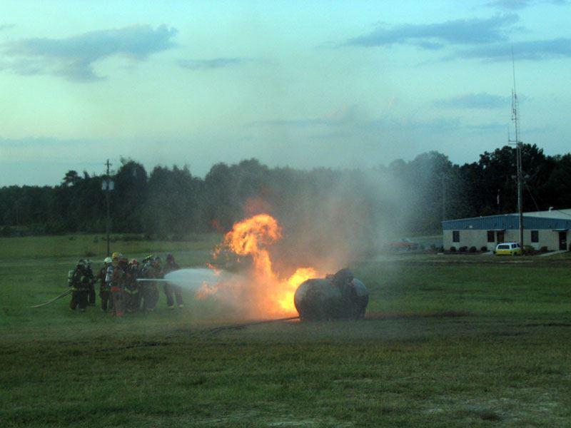 Firefighters Putting out a Pressurized Contained Fire
